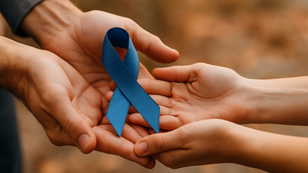 Close-up of hands gently holding a blue colon cancer awareness ribbon